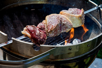 Picanha skewer cooks on the coals