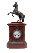 Red Marble Mantel Clock With A Figure Of A Horse On A White Background. Isolated.