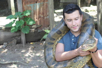 Wall Mural - Man with a giant Anaconda around his neck