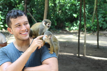 man establishing contact with wild monkeys