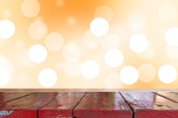 Wall Mural - Wooden desk with Gradient Abstract Blurred orange tone lights background