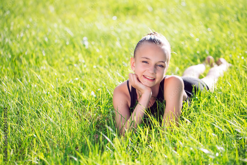 cute happy little girl lying on the grass Stock Photo | Adobe Stock