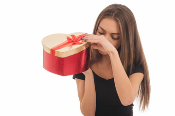 Portrait of a happy smiling girl in dress holding present box