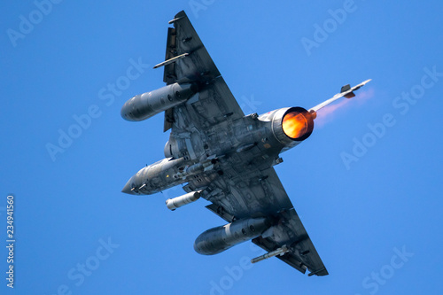 Tela Armed fighter jet plane in flight