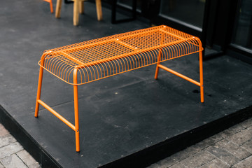 Orange decorative grid bench as a part of street cafe style