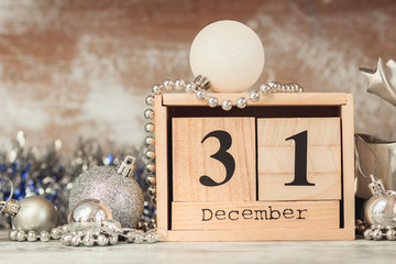 Hand changing wooden calendar with different New Year decorations