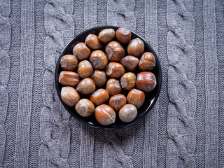 Hazelnut nuts in nutshells on natural background.