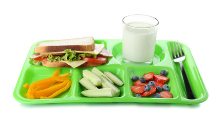 Serving tray with healthy food on white background. School lunch