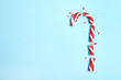 Broken candy cane and space for text on color background, top view