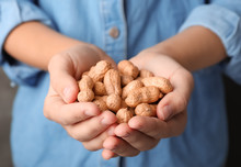 Woman Holding Raw Peanuts In Hands, Closeup
