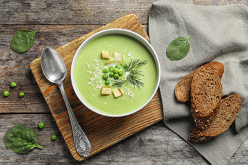 Fresh vegetable detox soup made of green peas served on table, top view