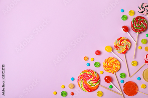 Plakat Flat lay composition with different candies and space for text on color background
