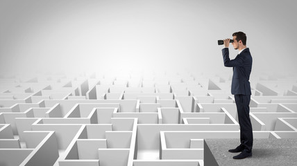 Wall Mural - businessman standing on maze and looking forward to the future concept