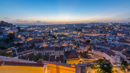 Wall Mural - Lisbon after sunset aerial panorama view of city centre with red roofs at Autumn day to night timelapse, Portugal