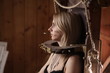beautiful blonde girl in lingerie on chair for torture suffering in barn with hay