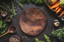 Food Cooking And Healthy Eating Background With Round Wooden Cutting Board And Fresh Seasoning, Spoon And Vegetables, Top View, Frame. Copy Space For Your Text And Design