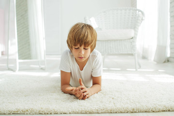 Wall Mural - Child  lying on the carpet  