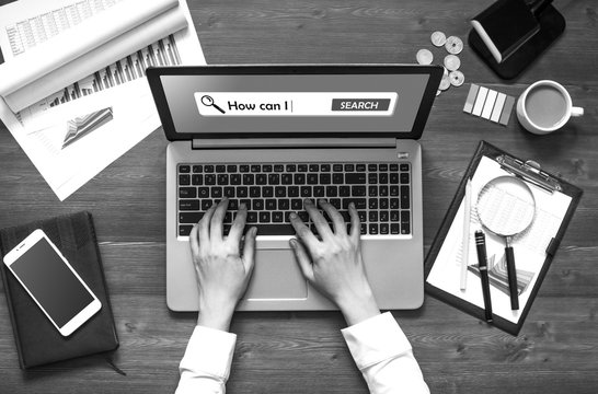 The woman (businesswoman, manager, student) working at office table (writes, calls, calculates, analyzes). Top view. With text How can I on searchbox on screen of laptop