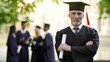 Confident man in graduation outfit, male obtaining degree, academic career