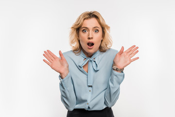 Canvas Print - shocked businesswoman gesturing with hands and looking at camera isolated on white