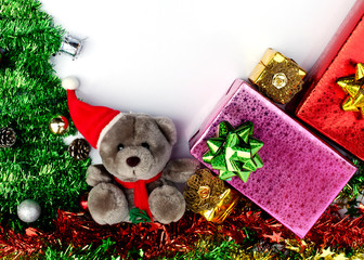 Teddy and gift box with Christmas decoration on white backgrounds above