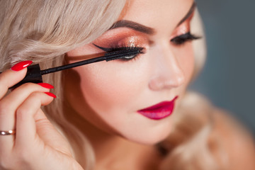 Wall Mural - Beautiful young blonde makes a bright holiday makeup. Glamorous make-up.