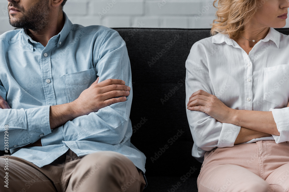 cropped shot of couple sitting on couch after quarrel Stock Photo ...