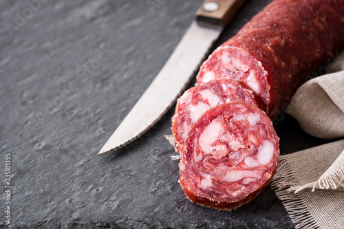 Cold meat chorizo on black slate background. Copyspace Fotobehang