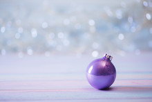 Purple Christmas Ball On Light Bokeh Background.