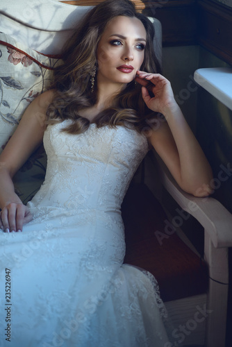 Beautiful Bride With Perfect Make Up And Wavy Hairstyle Wearing