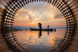 Silhouette of fishermen using nets to catch fish at the lake in Thailand morning light.