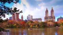 New York City Central Park In Autumn With Skyscrapers Apartment Boat And Lake