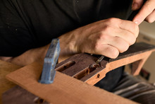 Luthier Makes Head Plate. Guitar Master Establishes An Overlay On The Head Of The Guitar.