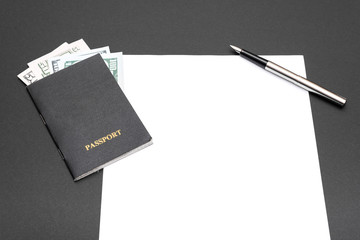 passport pen with money white sheet of paper lie on a black background.