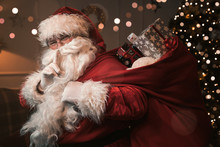 Santa Claus With Finger On The Lips Gesturing Shh Sign 