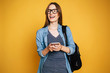 © My Ocean studio - Happy and excited cute young student girl portrait in glasses with backpack isolated in studio