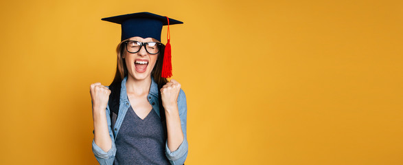 Study, education, university, college, graduate concept on banner. Happy and excited portrait of young student girl in hat of graduation isolated 