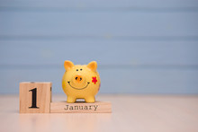 Calendar Date Of Financial Year Start, 1st January With Piggy Bank On Blue Background. Winter Time.