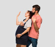 © luismolinero - Couple with pregnant woman fainting of childbirth on isolated grey background