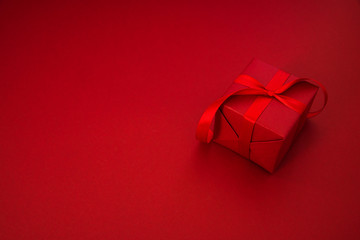 Wall Mural - red gift, present on red background. happy holidays greeting card.