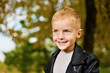 © Olek - Funny portrait of little sly boy in black leather jacket