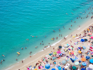 Wall Mural - Beach with crystalline sea crowded with swimmers. Top view.