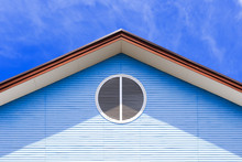 Gable Of House With Air Ventilate On Blue Sky Backgroung