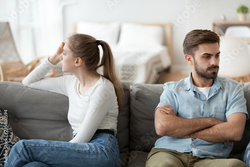 Fotografía Stubborn couple sit on couch back to back avoid talking after fight, offended man and woman separated on sofa ignoring one another, husband and wife not looking in eyes