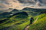 Fototapeta Na drzwi - Mountain biker riding through rough mountain landscape of Quiraing, Scotland