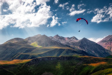 Landscape View Of Paraglider Flying Over Beautiful Mountains And Sky