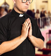 praying priest in a church