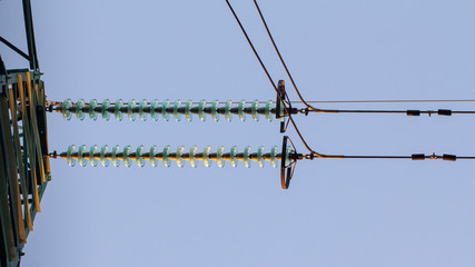 High voltage electricity transfer lines and pylon in a fog