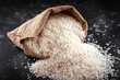 White raw basmati rice in burlap bag