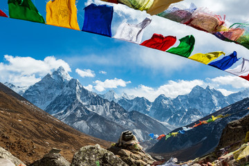 Nepal. From Lukla to Everest. Walk to Everest base camp. Square memorial to the fallen climbers. In the foreground are stones and Nepalese prayer flags, on the horizon of the mountain.